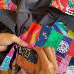 Lorena stitches kawandi with bright colourful fabrics.